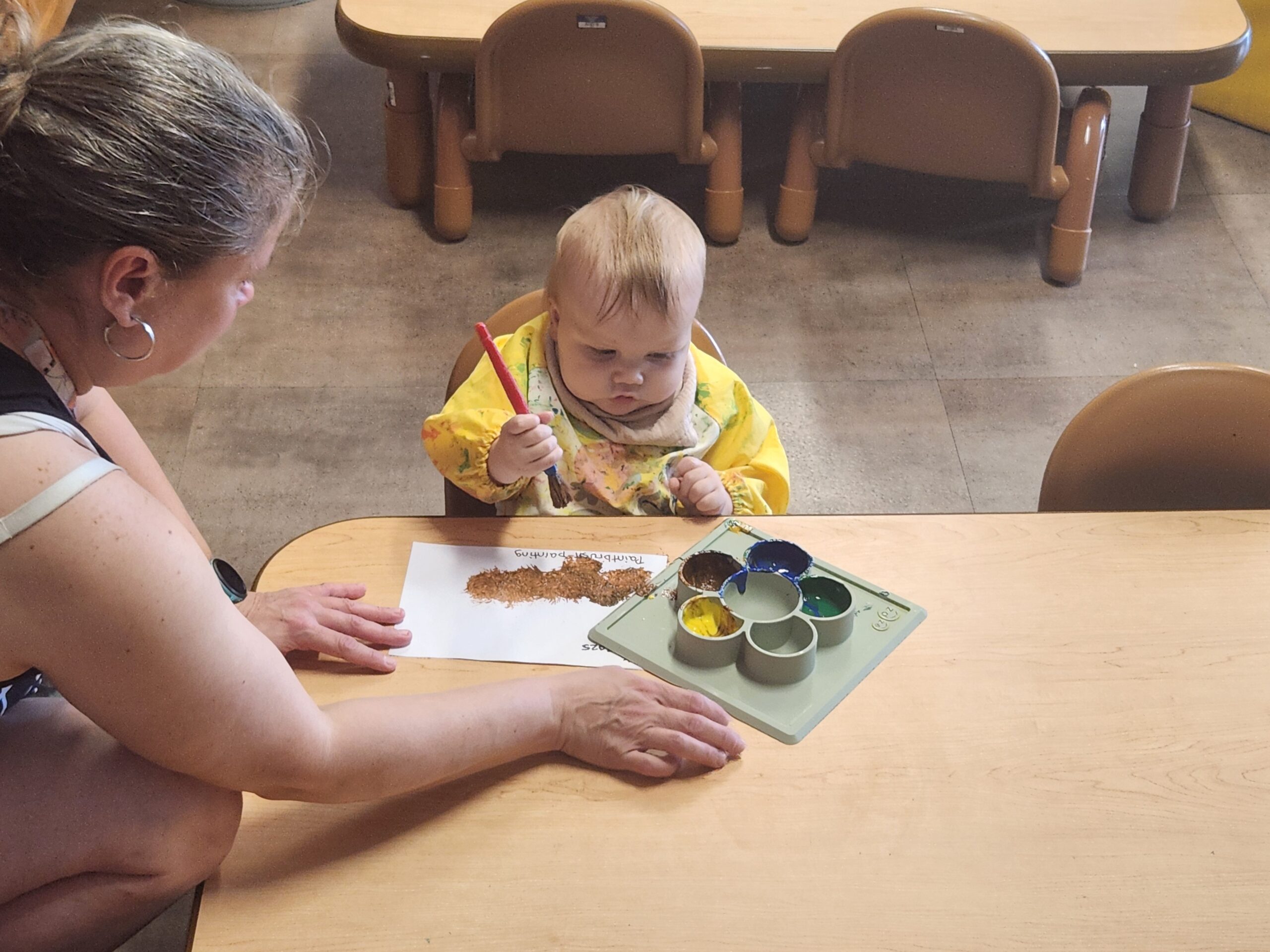 Toddler painting in Lancaster Early Education Center's toddler program