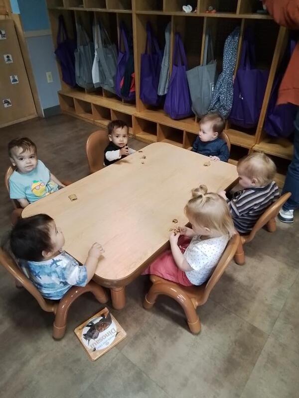 Toddlers sitting at a table having snack in Lancaster Early Education Center's Toddler program