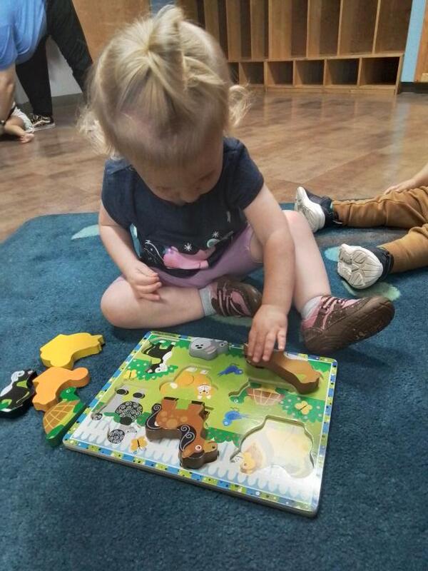Toddler doing a puzzle in Lancaster Early Education Center's Toddler classroom
