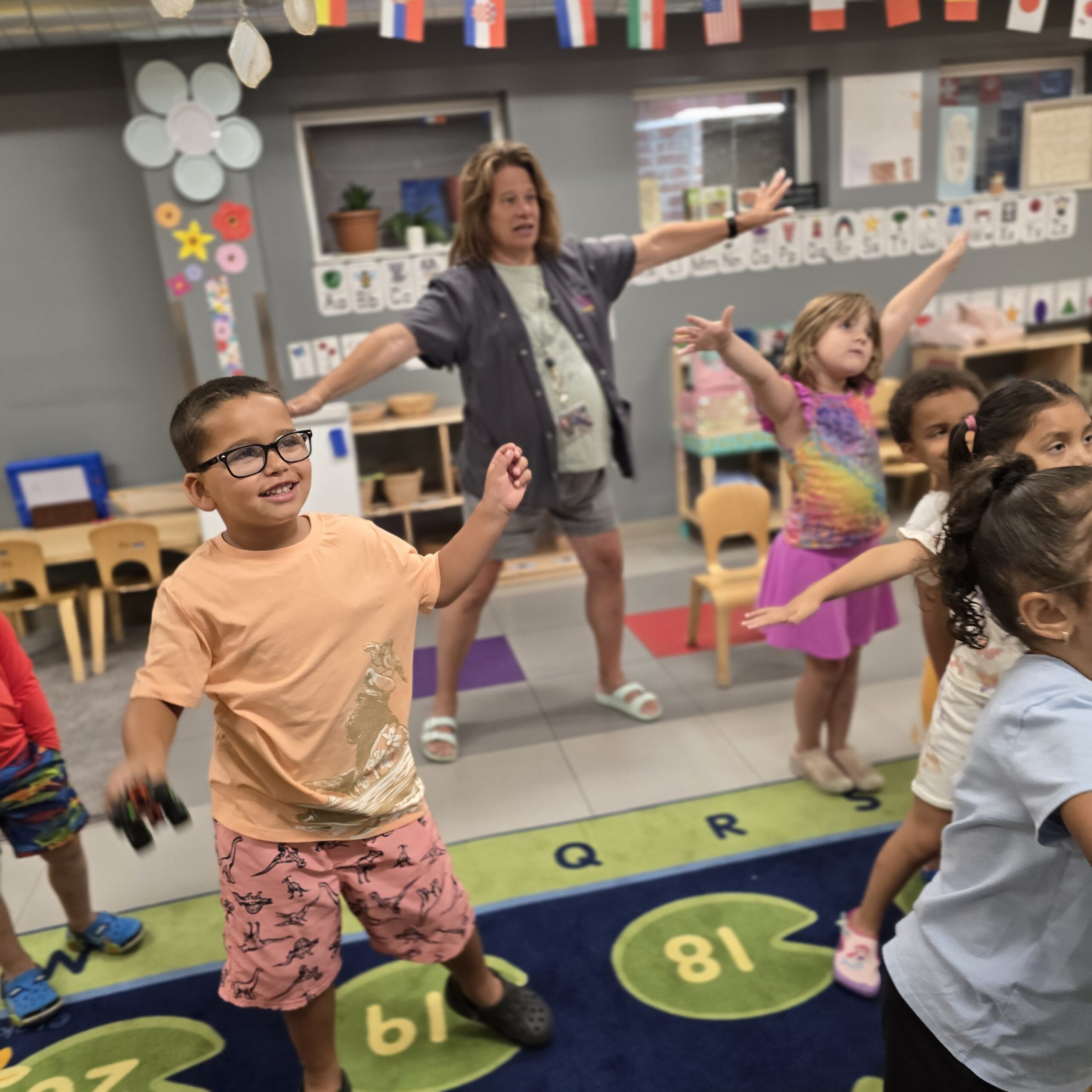 Children and Assistant teacher dancing at Lancaster Early Education Center