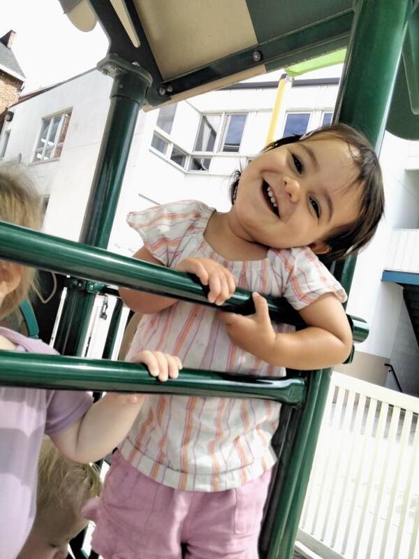 Girl playing at Lancaster Early Education Center outside on the playground