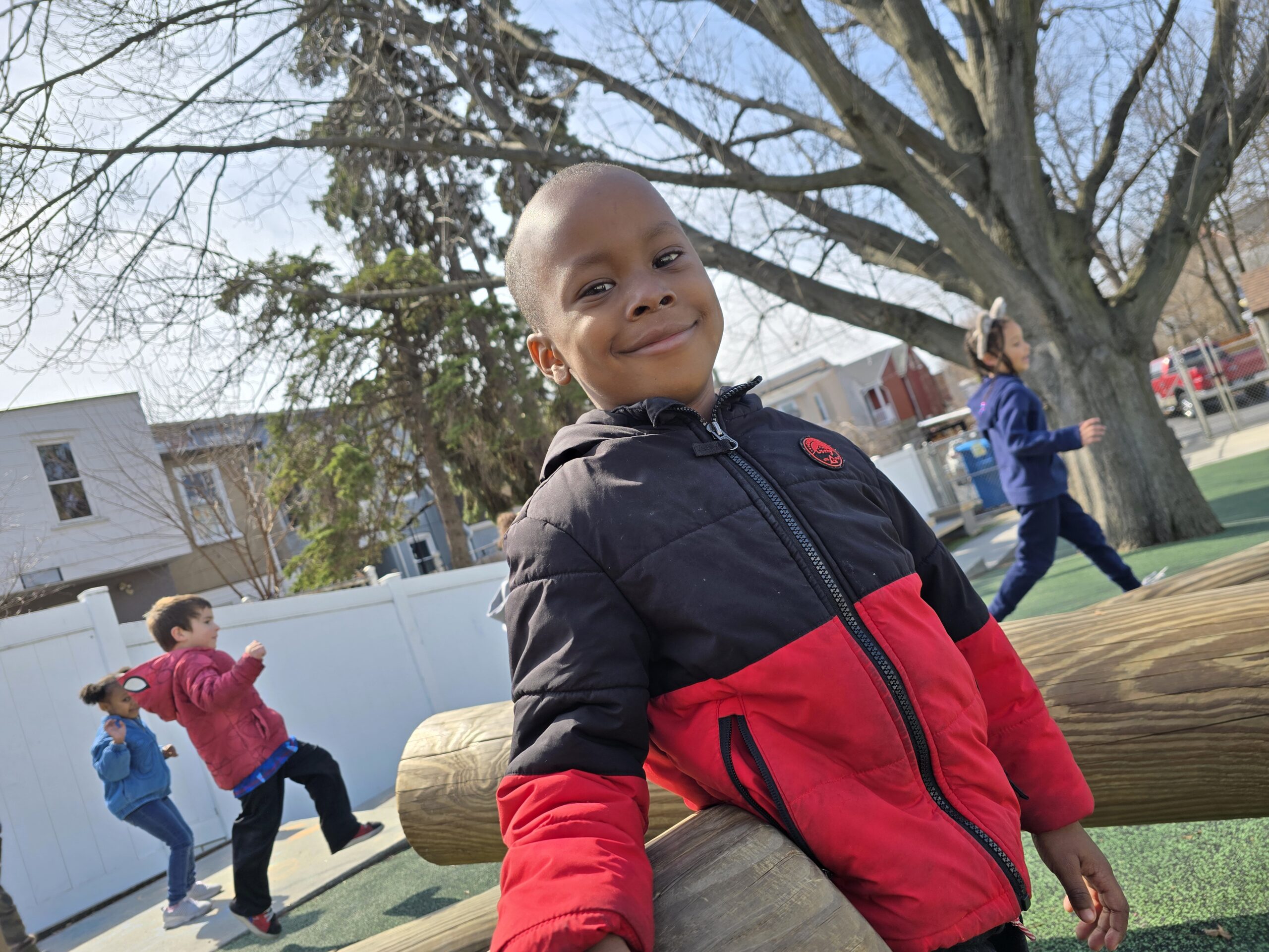 Holiday Activites at LEEC for Preschoolers – Preschooler on the playground in a winter coat Holiday Activites at LEEC for Preschoolers - Preschooler on the playground in a winter coat